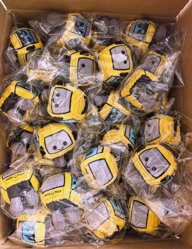 A bulk run of cable-car plush keychain charms, bagged and boxed ready for dispatch